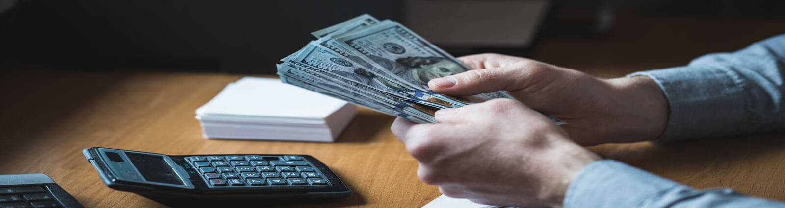 settle_payroll Counting money at a desk